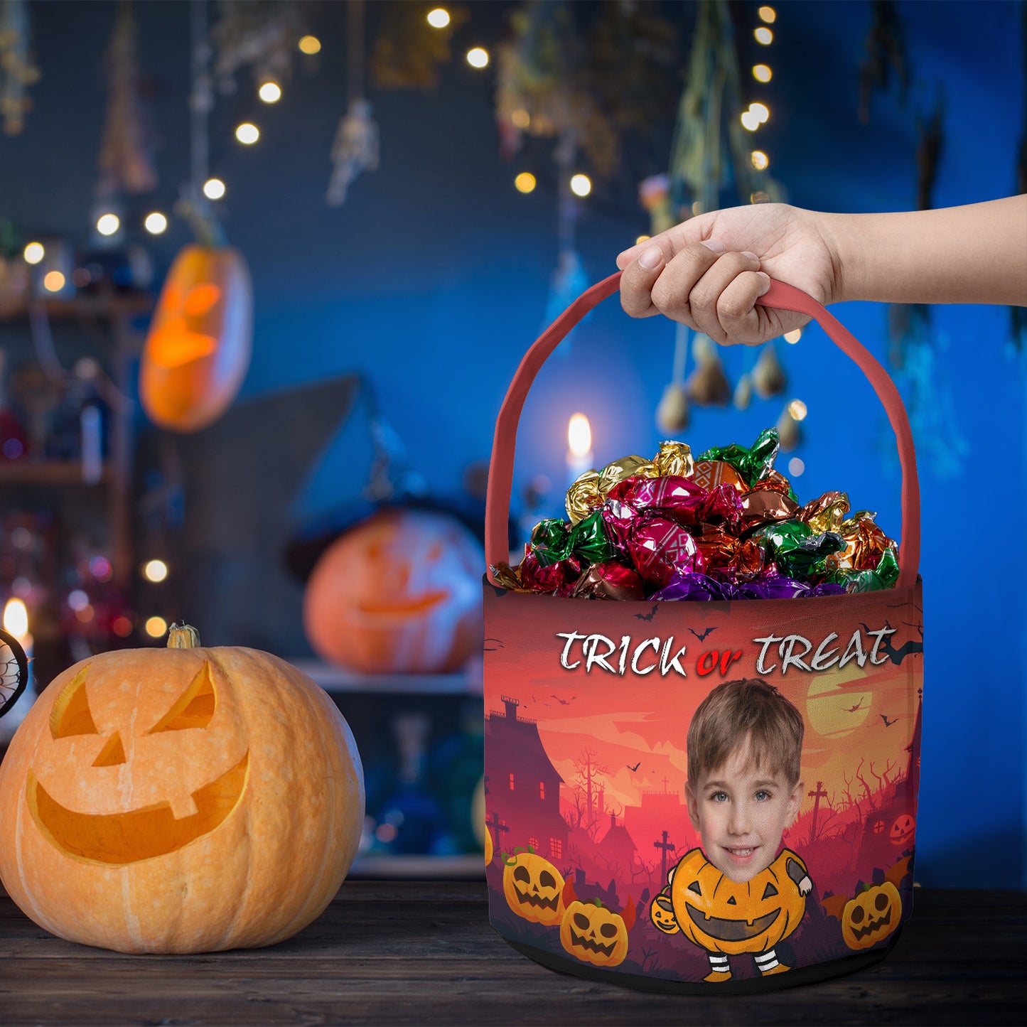Personalized Halloween candy bucket with custom child photo in pumpkin outfit, trick or treat bag filled with candy.