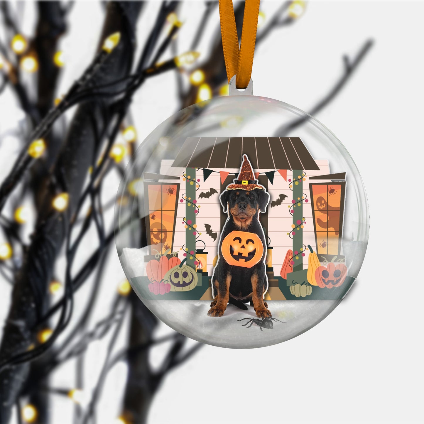 Clear glass ornament with custom pet photo hanging on orange ribbon