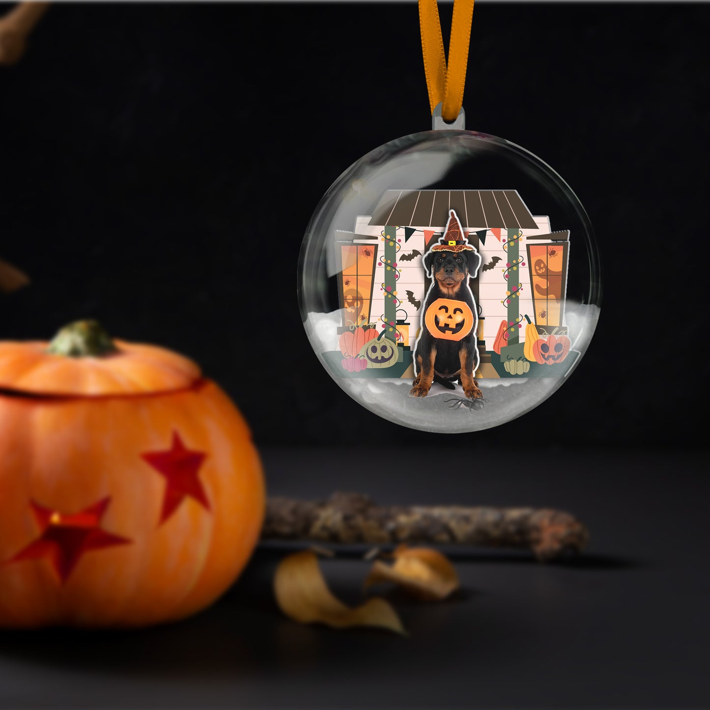 Halloween-themed ornament with a dog in a costume, pumpkins, and a black background.