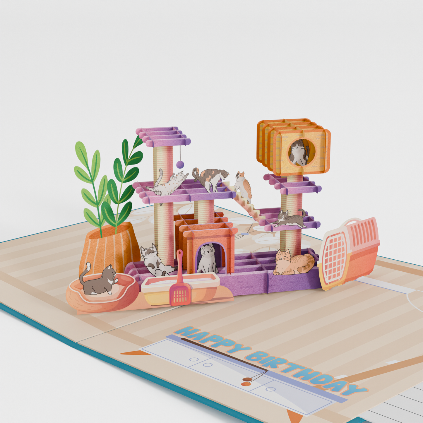 3D pop-up birthday card featuring colorful cat playground with multiple cats, scratching posts, and platforms. Card displays "Happy Birthday" text with heart and paw print decorations on teal background.