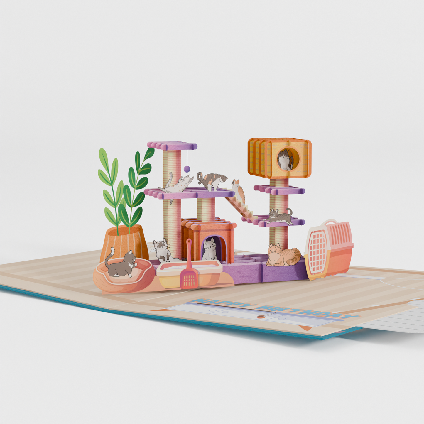 3D pop-up birthday card featuring colorful cat playground with multiple cats, scratching posts, and platforms. Card displays "Happy Birthday" text with heart and paw print decorations on teal background.
