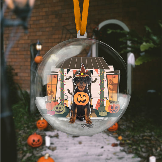 Decorative Halloween ornament with a dog in a pumpkin costume inside a clear bubble.